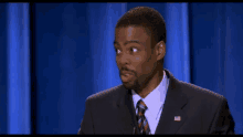 a man in a suit and tie with an american flag on his neck