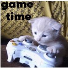 a kitten playing a video game with the words game time written above it