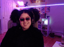 a woman wearing headphones and sunglasses smiles in front of a shelf that says ebay on it