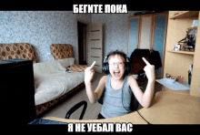 a boy wearing headphones is giving the middle finger in a meme