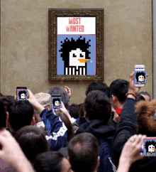 a group of people are taking pictures of a pixelated penguin that says most wanted