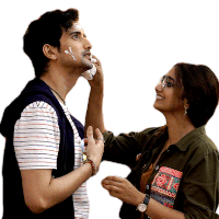 a woman is applying cream to a man 's face while he looks up