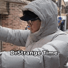 a person wearing a hooded jacket with the words drstrange time on the bottom