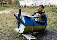 a man is sitting in a barrel with a propeller on it