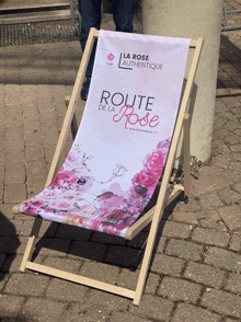 a chair that says route de la rose sits on a brick sidewalk