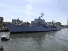 a large navy ship with the number j19 on the side