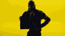 a silhouette of a man with dreadlocks dancing on a yellow background