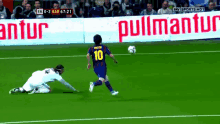 a soccer player wearing a number 10 jersey kicks a ball