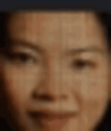 a close up of a woman 's face with a blurred background