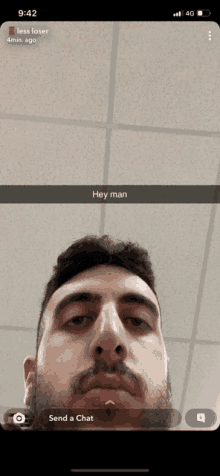 a man 's face is shown on a phone screen with the words hey man below it