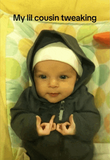 a baby wearing a hooded jacket and a white hat with the words my lil cousin tweaking above him