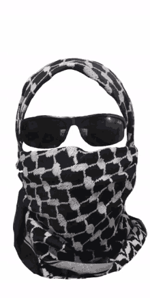 a person wearing sunglasses and a black and white scarf