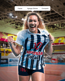 a woman wearing a jersey that says " apuesta total " on it