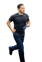 a man in a black shirt is running with a pamphlet in his hand