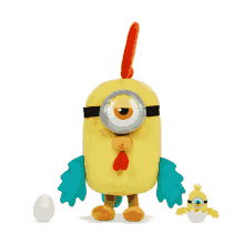 a stuffed toy of a minion dressed as a chicken with an egg next to it