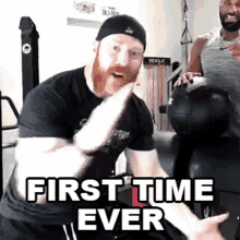 a man with a beard is holding a medicine ball in a gym with the words `` first time ever '' written above him .