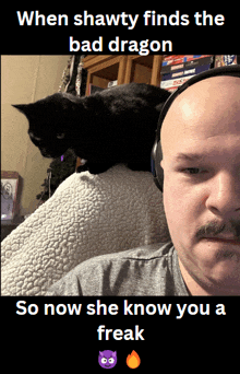 a bald man with a mustache and a cat on his head