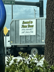 a truck with a sign that says second to none trees on it