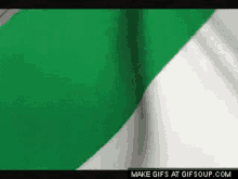 a green and white cloth is waving in the wind .