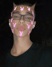 a young man with glasses and pink playboy bunny face paint