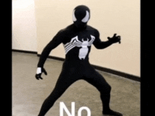 a man in a venom costume is standing on the floor