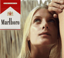 a pack of marlboro cigarettes next to a woman 's face