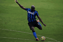 a soccer player with the number 9 on his jersey kicking a ball