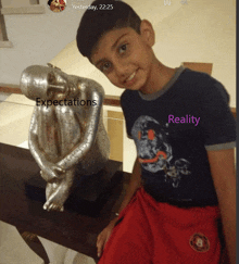 a young boy stands in front of a statue that says expectations