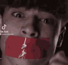 a man with a red tape over his mouth has tiktok written on the bottom