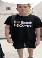 a young man wears a black shirt that says i heart hot moms