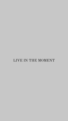 it is a quote that says `` live in the moment '' on a gray background .