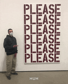 a man wearing a mask stands in front of a painting that reads please