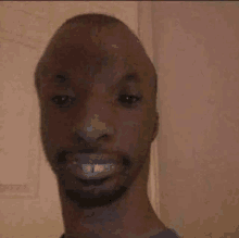 a close up of a man with a beard smiling .