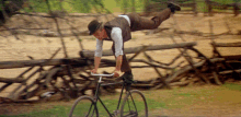 a man is doing a trick on a bicycle