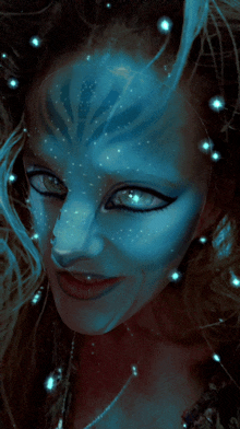 a close up of a woman 's face with blue paint