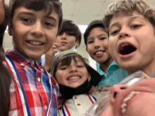 a group of young boys are posing for a picture and one boy is wearing a mask