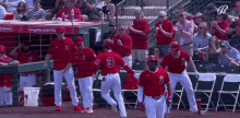 a group of baseball players are standing on a field . one of the players has the number 3 on his back .