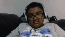 a boy wearing headphones and a shirt that says bruh on it