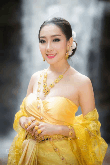 a woman in a yellow dress with the word 500px on the bottom