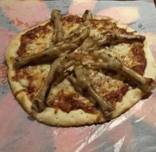 a pizza with chicken feet on it on a piece of paper