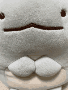 a close up of a stuffed animal that looks like a shark