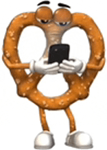 a pretzel mascot is holding a cell phone in his hands .