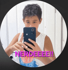 a boy taking a picture of himself with the words nerdeeee on the bottom right