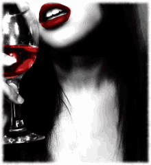 a woman with red lips is holding a wine glass