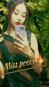 a woman in a green dress taking a selfie with the name miss preet on the bottom