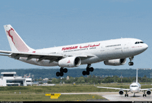 a tunisiair airplane taking off from an airport runway