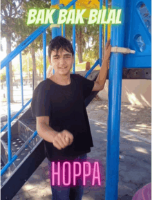 a boy standing in front of a playground with the words bak bak bilal hoppa written on the bottom