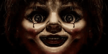 a close up of a creepy doll 's face with blood coming out of her eyes .