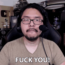 a man wearing glasses and a headset says fuck you