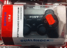 a fony dualshock wireless controller sits in a box